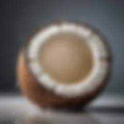 A perfectly opened coconut showcasing its inner flesh and water