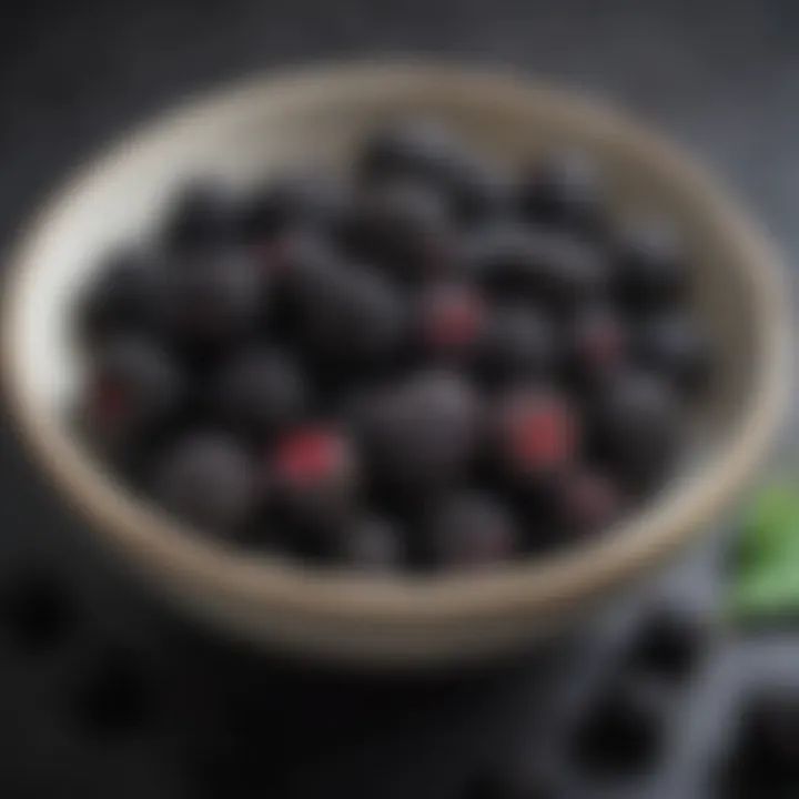 A vibrant bowl filled with fresh black mulberries