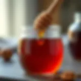 A close-up of chestnut honey in a glass jar with a wooden dipper