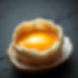 Close-up of a cracked egg revealing the yolk and white